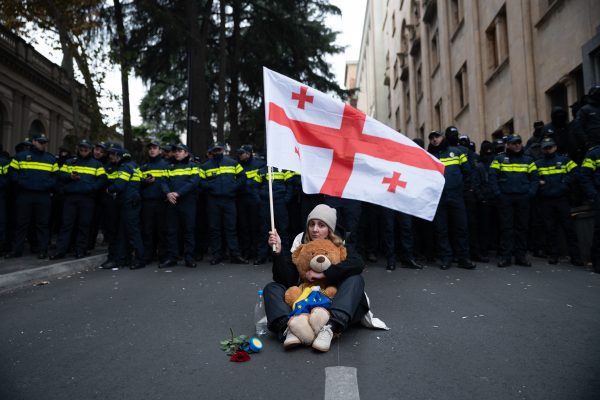 Photo: Georgia, Tbilisi, 2024/11/25. A woman waves a Georgian flag in front of the police, who are guarding the entrance to the parliament. As the first session of the newly elected Parliament is scheduled for today, November 25, members of opposition parties have announced their intention to boycott it. Numerous protesters are demonstrating outside the Parliament entrance, where some spent the night. Photograph by Maurizio Orlando/ Hans Lucas. Georgie, Tbilissi, 2024/11/25. Sur la photo : Une femme brandit un drapeau georgien devant la police, qui protege l entree du parlement. Alors que la premiere session du Parlement recemment elu est prevue aujourd hui, le 25 novembre, les membres des partis d opposition ont annonce leur intention de la boycotter. De nombreux manifestants protestent devant l entree du Parlement, ou certains ont passe la nuit. Credit: Maurizio Orlando/ Hans Lucas via Reuters