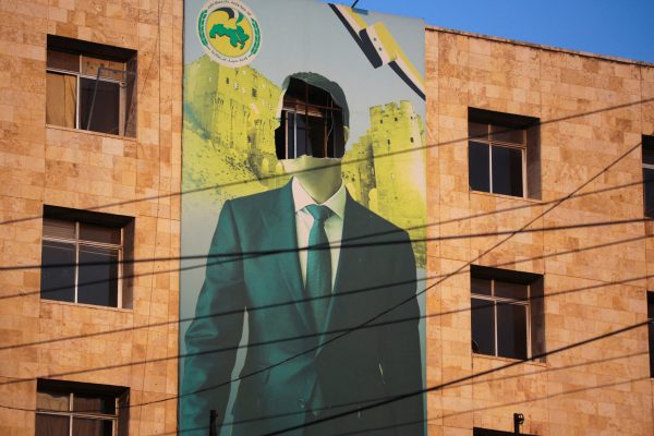 Photo: A view shows a damaged poster of Syria's President Bashar al-Assad in Aleppo, after the Syrian army said that dozens of its soldiers had been killed in a major attack by rebels who swept into the city, in Syria November 30, 2024. Credit: REUTERS/Mahmoud Hassano