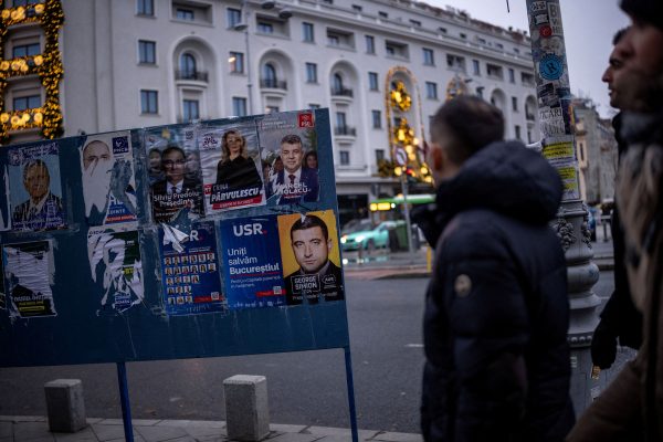 Photo: People walk past posters depicting Prime Minister Marcel Ciolacu and Leader of the radical right Alliance for Uniting Romanians (AUR) George Simion, a day before the parliamentary election, in Bucharest, Romania, November 30, 2024. Credit: REUTERS/Alkis Konstantinidis