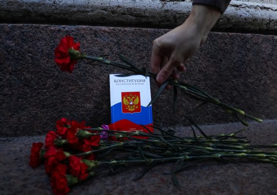 Photo: An activist places flowers next to a copy of the Russia's constitution during a protest against Russia's parliament approved amendments to the constitution, including a stipulation to allow President Vladimir Putin to run for president in 2024, in Saint Petersburg, Russia March 15, 2020. Credit: REUTERS/Anton Vaganov