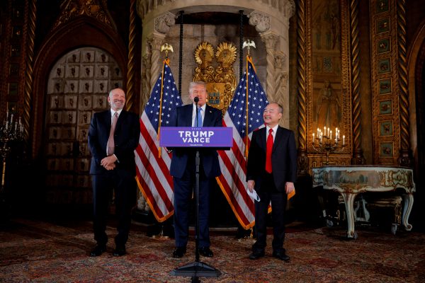 Photo: U.S. President-elect Donald Trump delivers remarks next to Chairman and CEO of SoftBank Masayoshi Son and CEO of Cantor Fitzgerald and Trump's nominee for Commerce Secretary Howard Lutnick, at Mar-a-Lago in Palm Beach, Florida, U.S., December 16, 2024. Credit: REUTERS/Brian Snyder