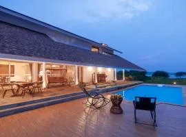 StayVista's Eva Villa - Lakeside Luxury with Modern Decor, Pool & Expansive Lawn - Near Sula