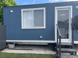 Sweet Cute blue tiny home with Pool and 2 minute drive to the beach