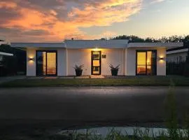 Luxury villa with veranda screen SUPs and canoe