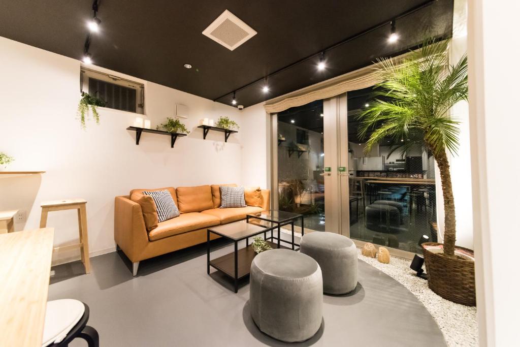 a living room with a couch and a table at KIZUNA HOTEL Gojo Kiyomizu-dera Kamogawa in Kyoto