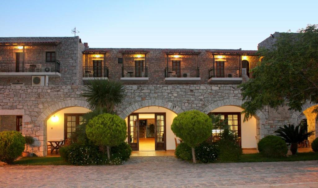 a large stone building with trees in front of it at Kastro Maini in Areopolis