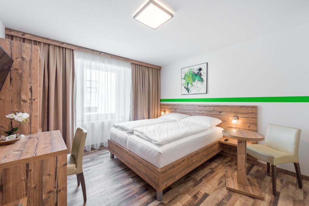 Tempat tidur dalam kamar di City Rooms Wels - contactless check-in