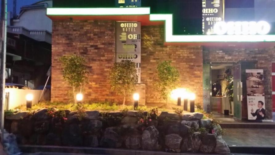 a brick building with lights in front of it at OHHO Hotel in Gimhae