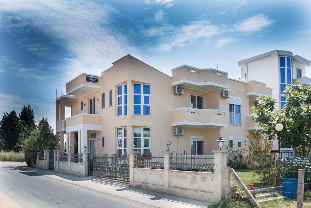 a large house with a fence in front of it at Apartments Sija in Ulcinj