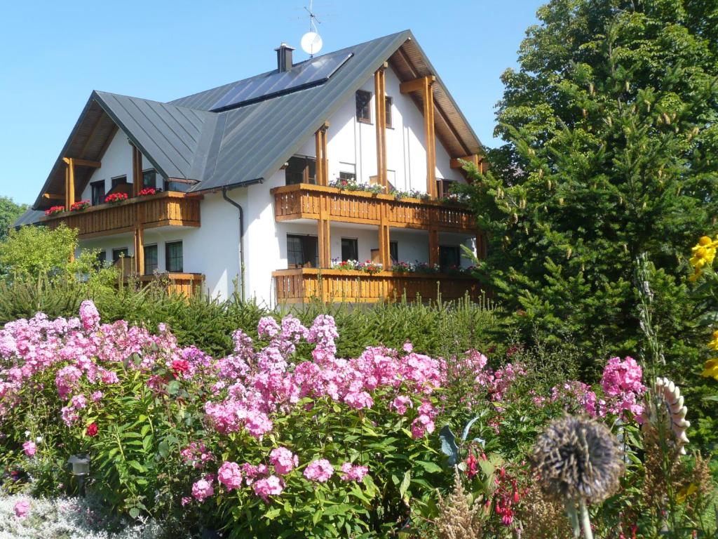 una casa con un mazzo di fiori davanti di Hotel Bergblick a Warmensteinach