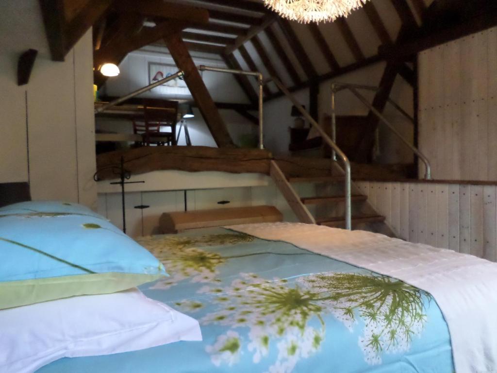 Schlafzimmer mit einem Bett und einem Kronleuchter in der Unterkunft B & B De Pimpelmees in 's-Gravenmoer