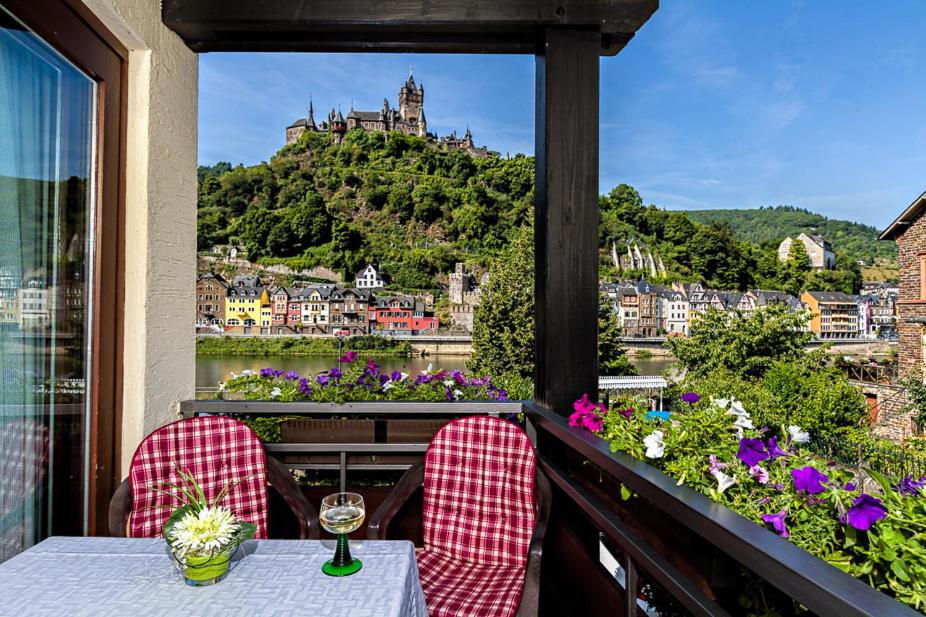 a balcony with a table and a view of a city at Apartments Haus Daniela in Cochem