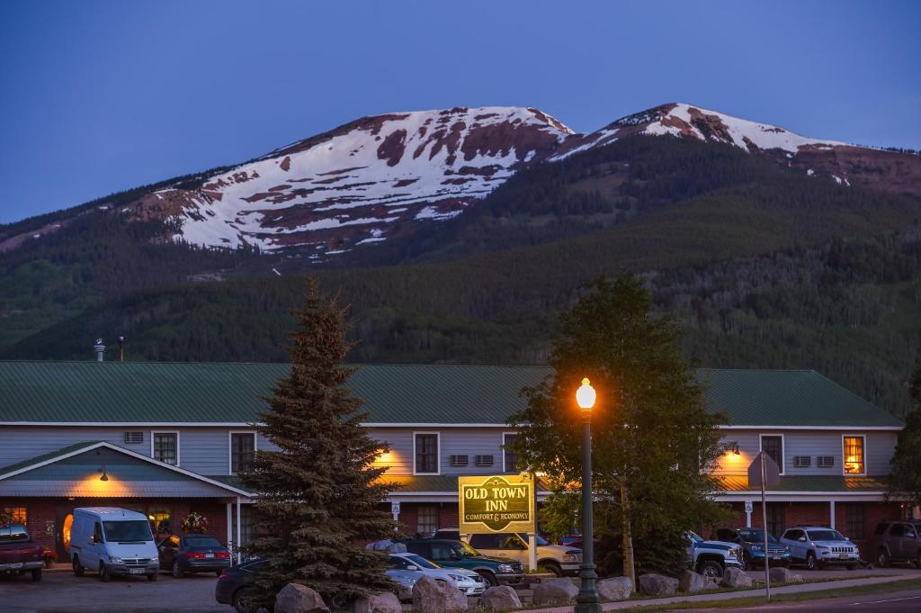 un bâtiment avec une montagne en arrière-plan et un éclairage de rue dans l'établissement Old Town Inn, à Crested Butte