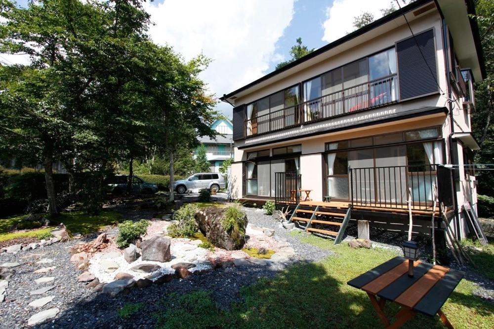 a house with a bench in front of it at Midorian in Nikko