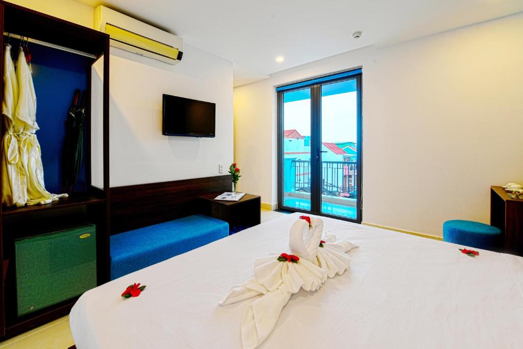 Giường trong phòng chung tại Hoi An Dream City Hotel