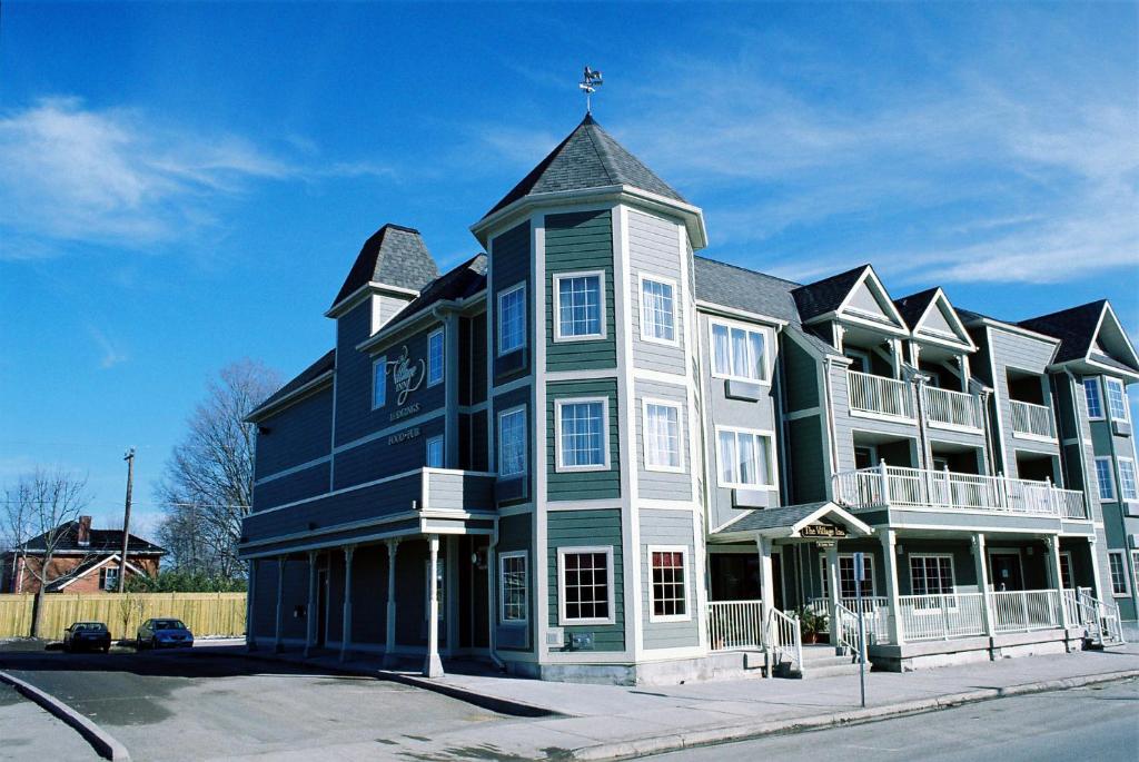 a large blue and white building with a cross on top at The Village Inn of Lakefield in Lakefield