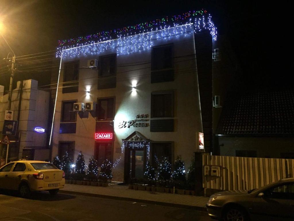 a building with blue christmas lights on it at Pensiunea El Passo Targu Mures in Târgu-Mureş