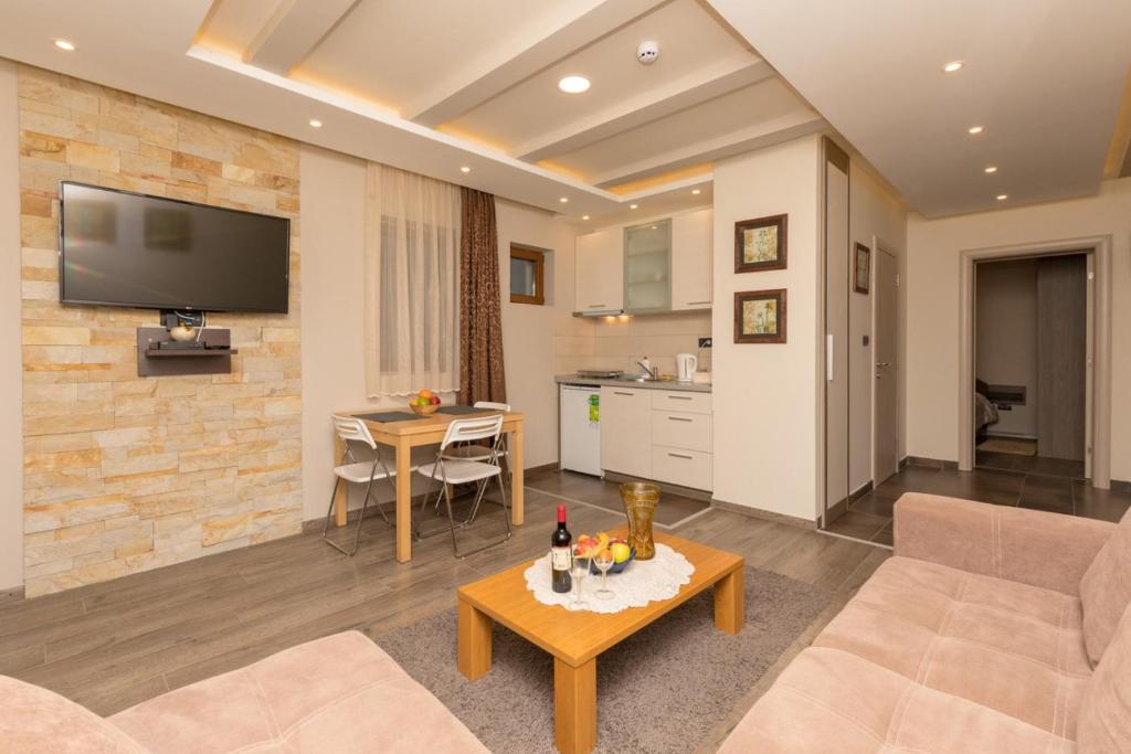 a living room with a couch and a table at Apartment Milmari Sunny View G3 in Kopaonik