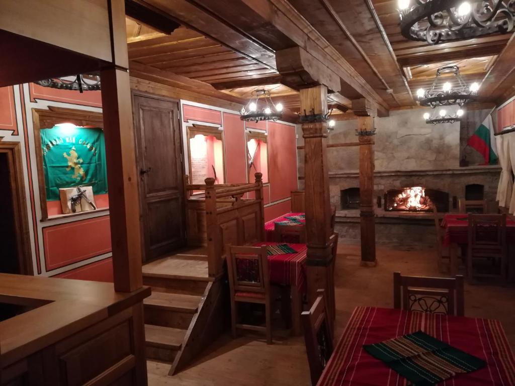 a restaurant with a fireplace and tables and chairs at Once upon a time in Koprivshtitsa