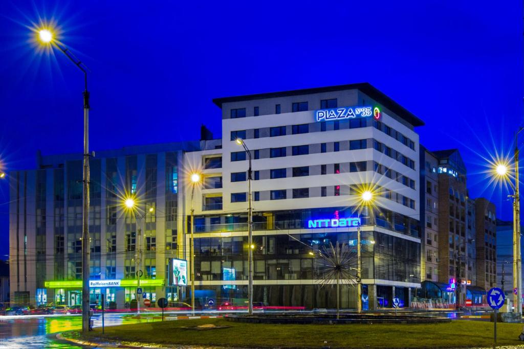 a building with a sign on it at night at Plaza35 in Sibiu