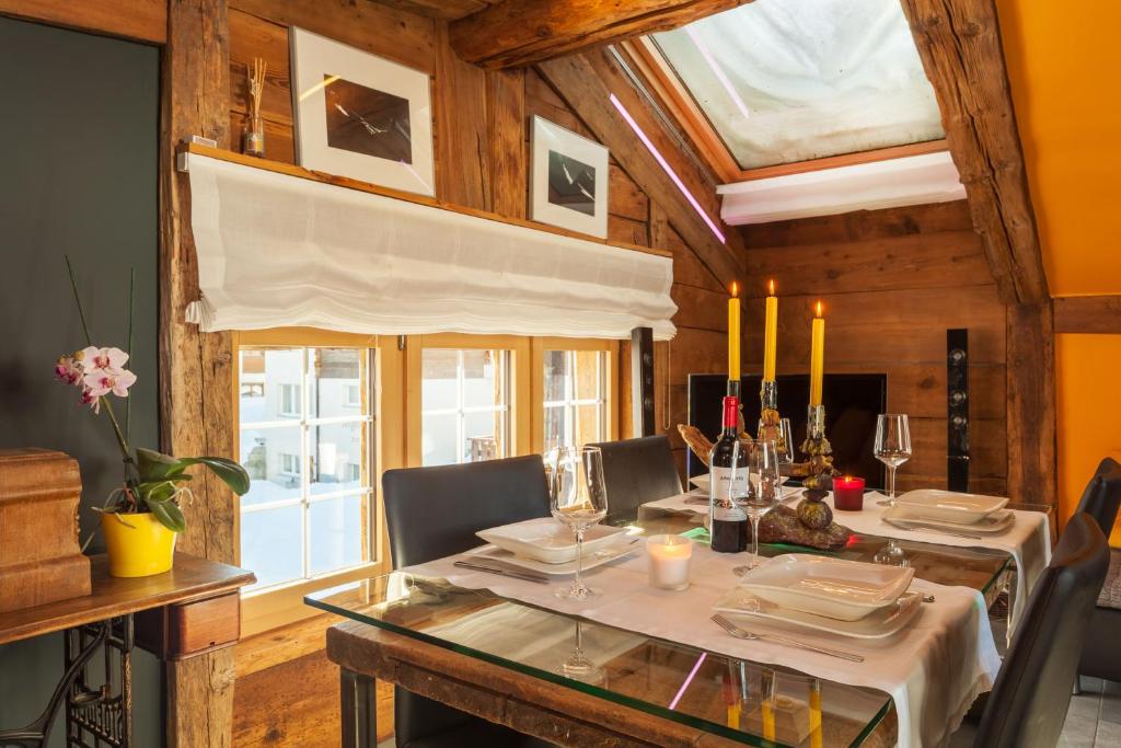 a dining room with a table and chairs and a window at Chalet Schtuba in Zermatt