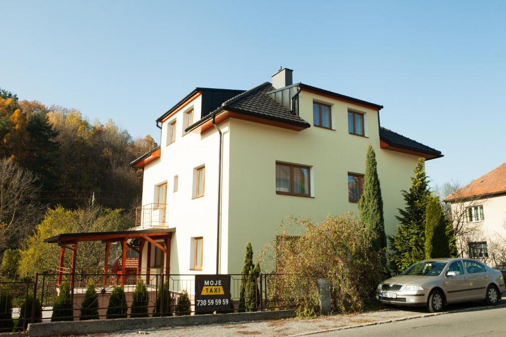 a house with a car parked in front of it at Vila Sofia in Luhačovice