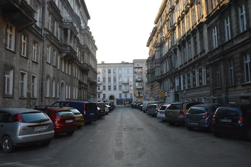 une rangée de voitures garées dans une rue abritant des bâtiments dans l'établissement Ada Aparthouse, à Wrocław