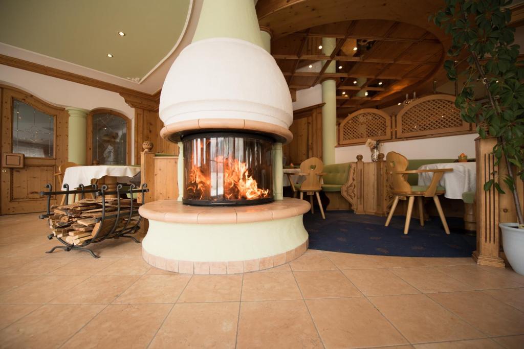 a fireplace in the middle of a room at Villa Rier in Siusi