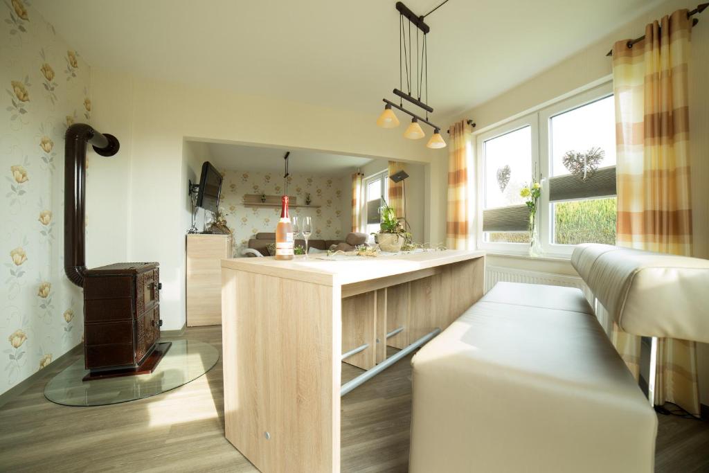 a kitchen with a counter with a sink and a window at Gästehaus Marichen in Aurich