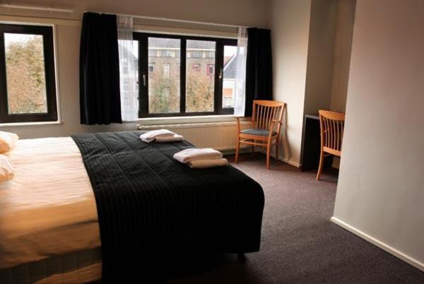 a bedroom with a bed with two towels on it at Royal in Deventer