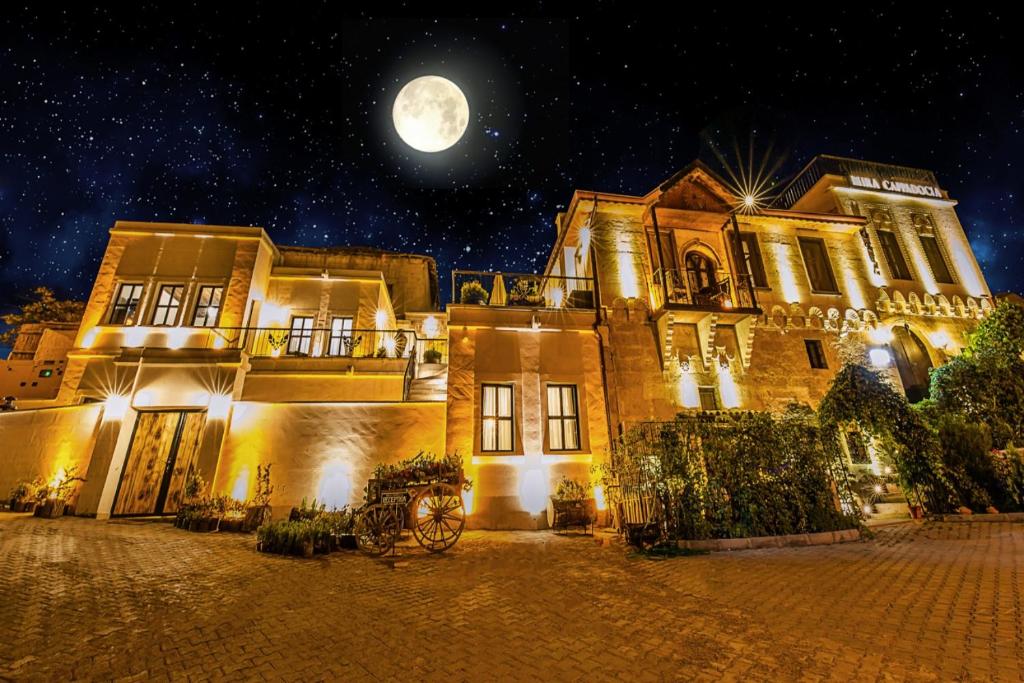 an old house with a full moon in the sky at Mira Cappadocia Hotel in Avanos