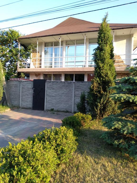 a house with a fence in front of it at Таунхаус 99 in Petropavlovskaya Borshchagovka