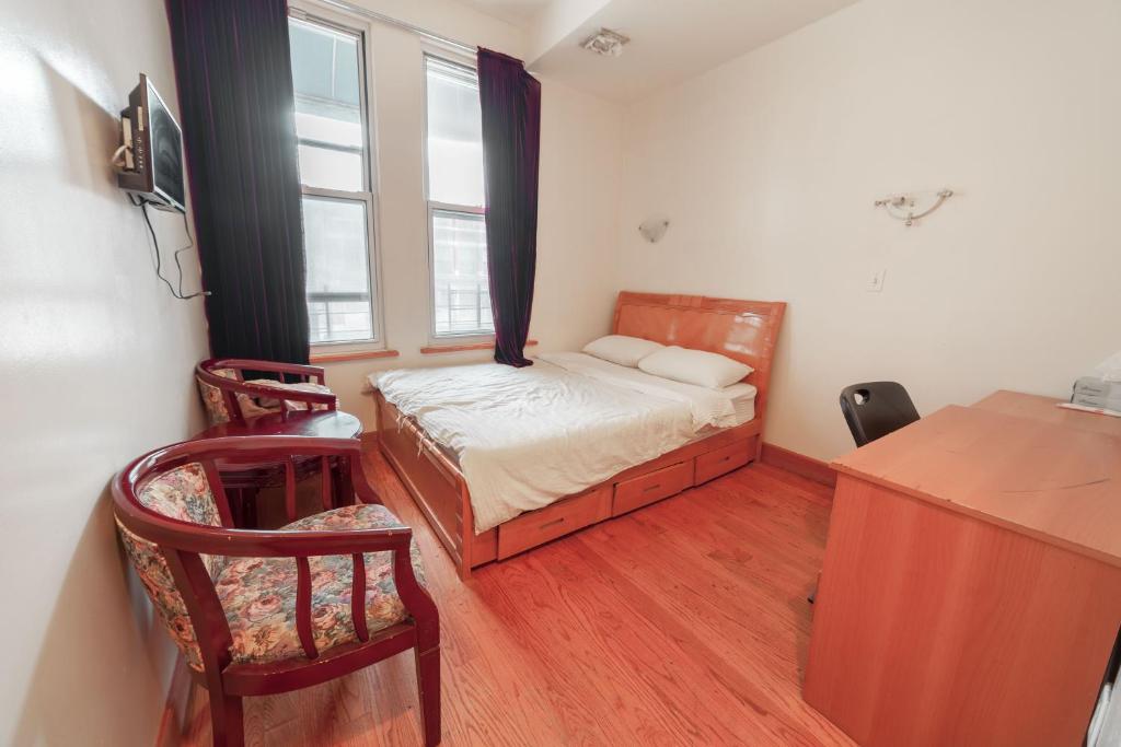 a small bedroom with a bed and a window at U.S. Pacific Hotel in New York