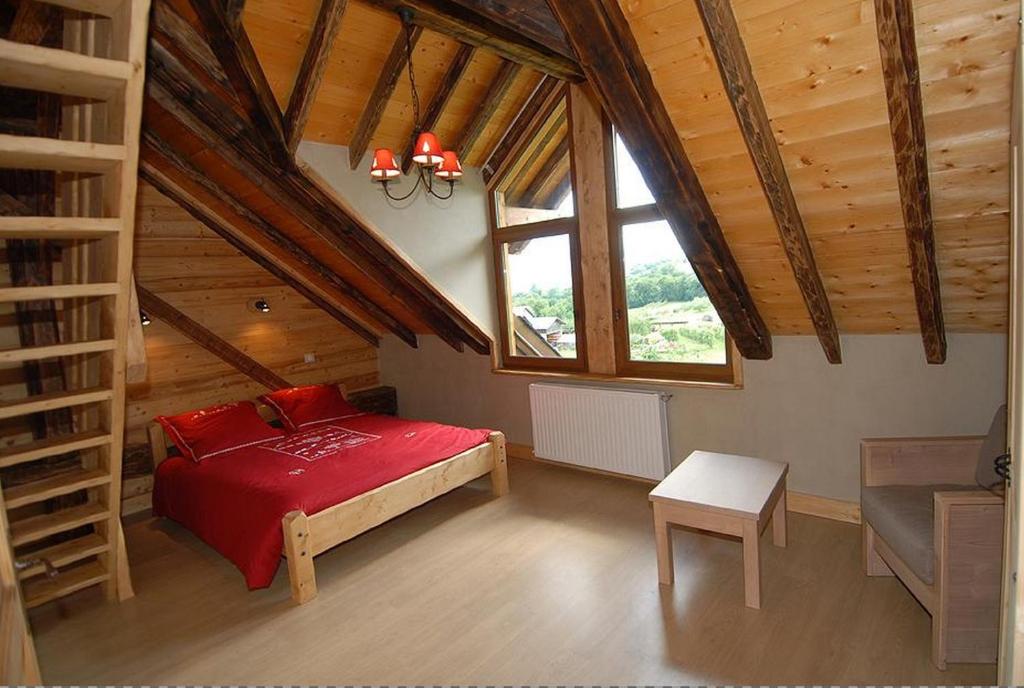 A bed or beds in a room at La Ferme De Noémie