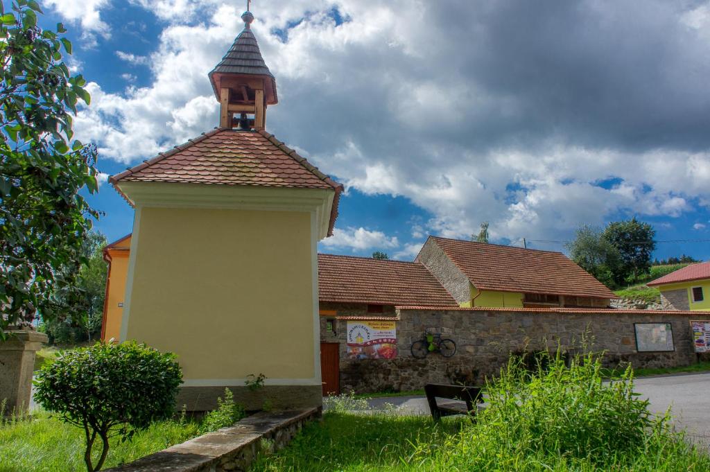 a small building with a tower on top of it at Apartmány U kapličky in Kamýk nad Vltavou