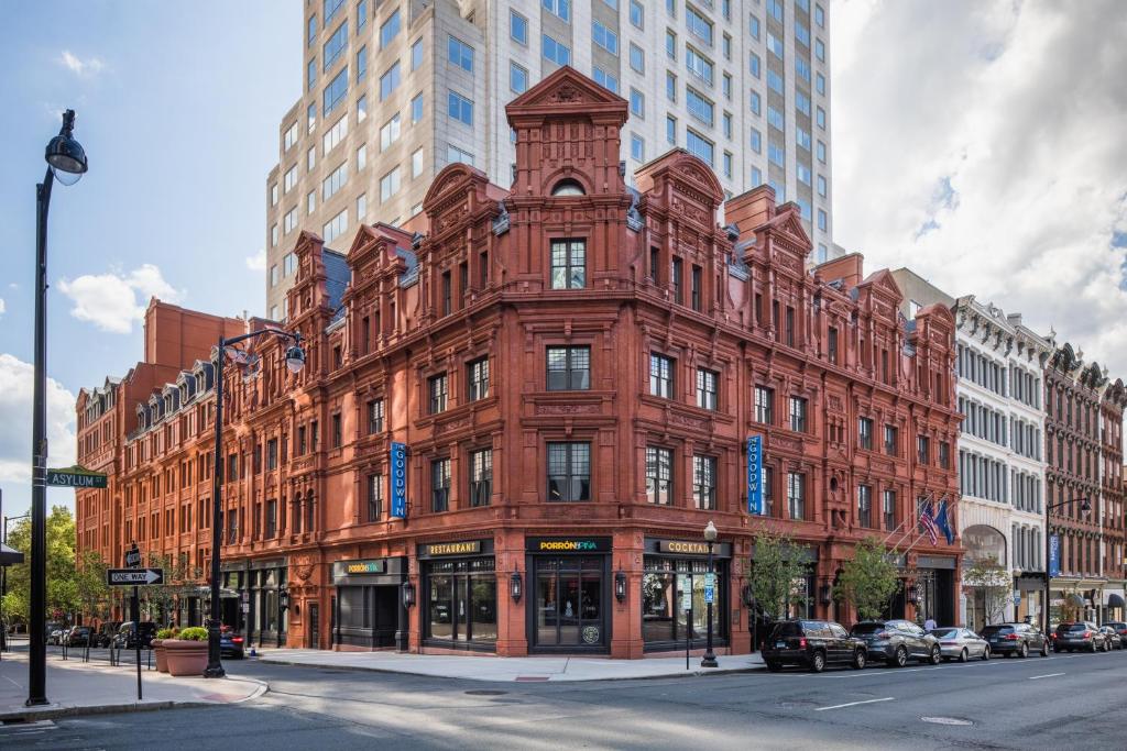 a large red brick building on a city street at The Goodwin in Hartford