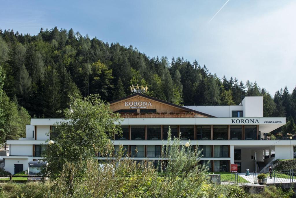 a building with a mountain in the background at Korona, Resort & Entertainment in Kranjska Gora