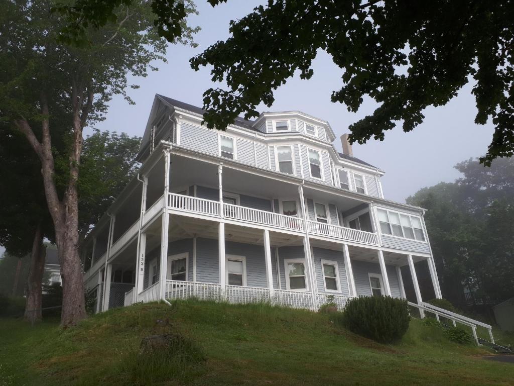 a large white house on top of a hill at Hillside Landing B&B in Digby