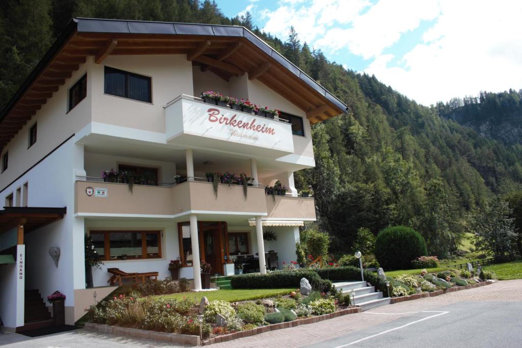 a building with a sign for a hotel at Birkenheim Widmann in Längenfeld