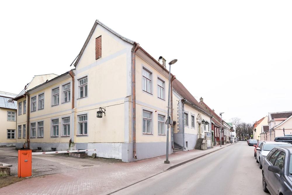 a white building on the side of a street at Kuninga City Center Apartment in Pärnu