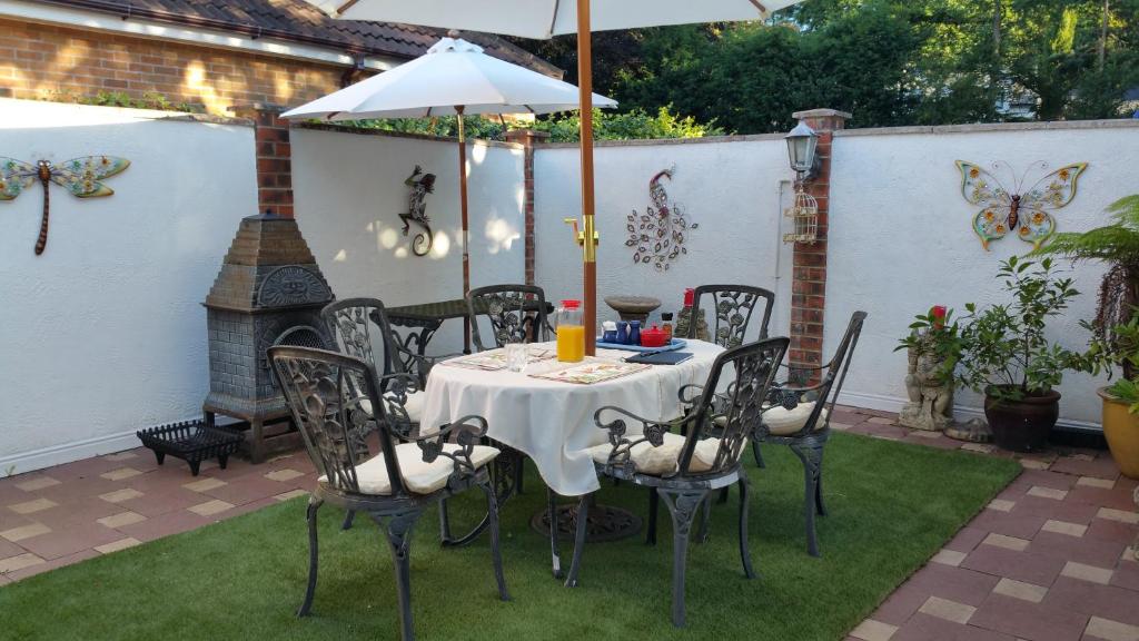 a table and chairs with an umbrella on a patio at Best Area Close to Leeds Centre in Leeds