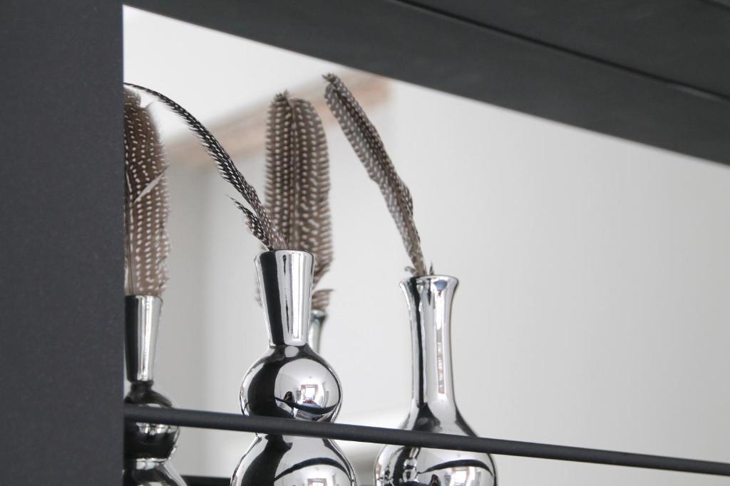 a group of utensils sitting on a shelf at Junior Suite The Backyard TBY 01 in Trier