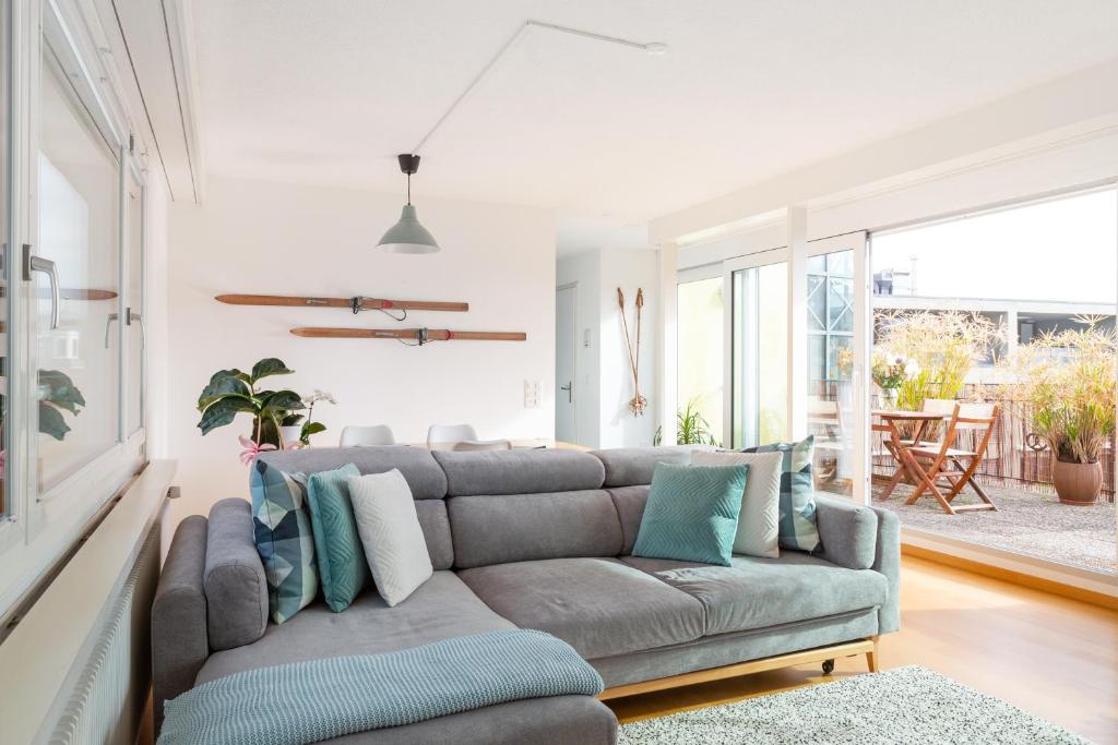 a living room with a couch and a table at Modern & Central Apartments in Luzern