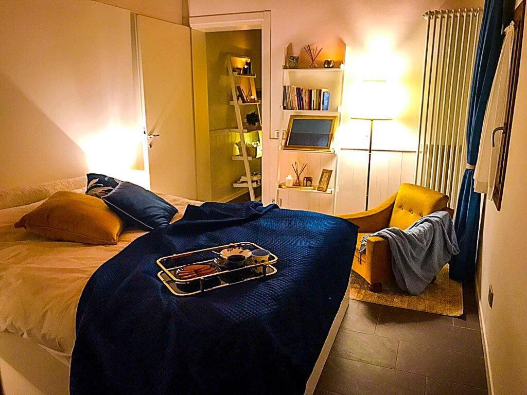 a bedroom with a bed with a tray on it at Papere e Tulipani in Vicenza