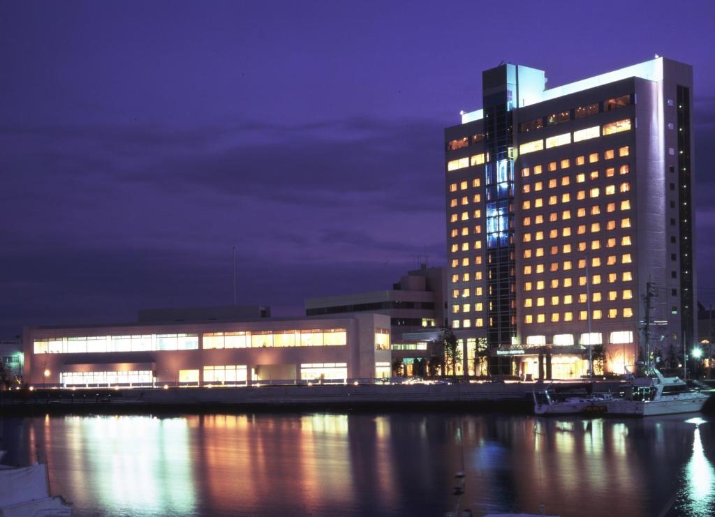 a large building with lit up windows at night at Tokushima Grandvrio Hotel in Tokushima