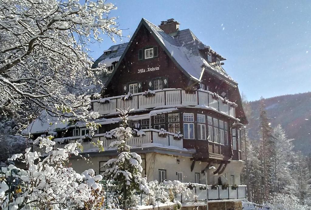 duży dom pokryty śniegiem w górach w obiekcie Villa Daheim Semmering w mieście Semmering