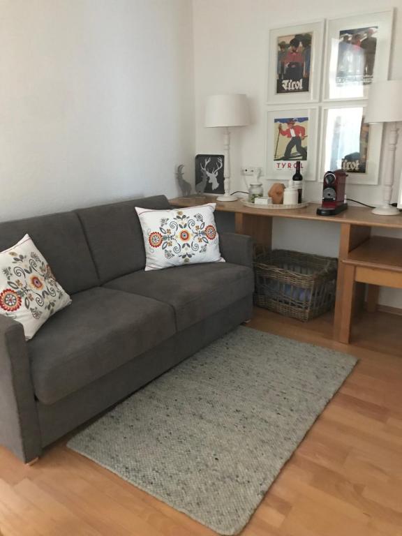 a living room with a couch and a desk at Appartement Gurgl in Obergurgl