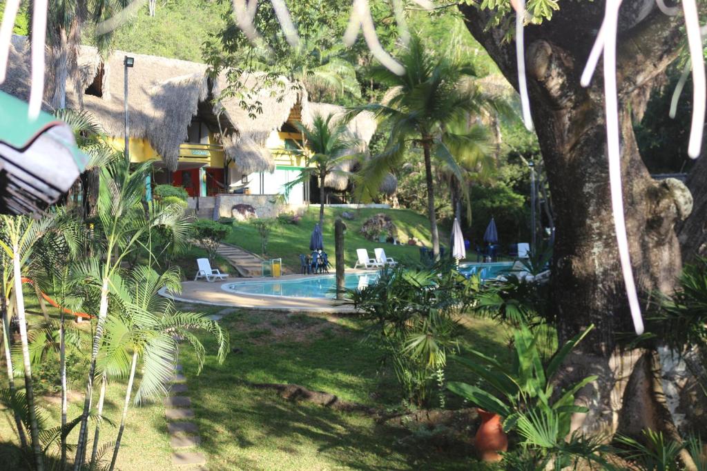 un resort con piscina e palme di Eco Hotel El Reposo a Melgar