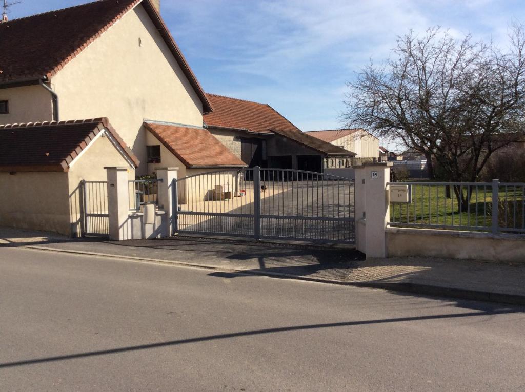 un cancello di fronte a una casa con una recinzione di Maison d’izier a Izier