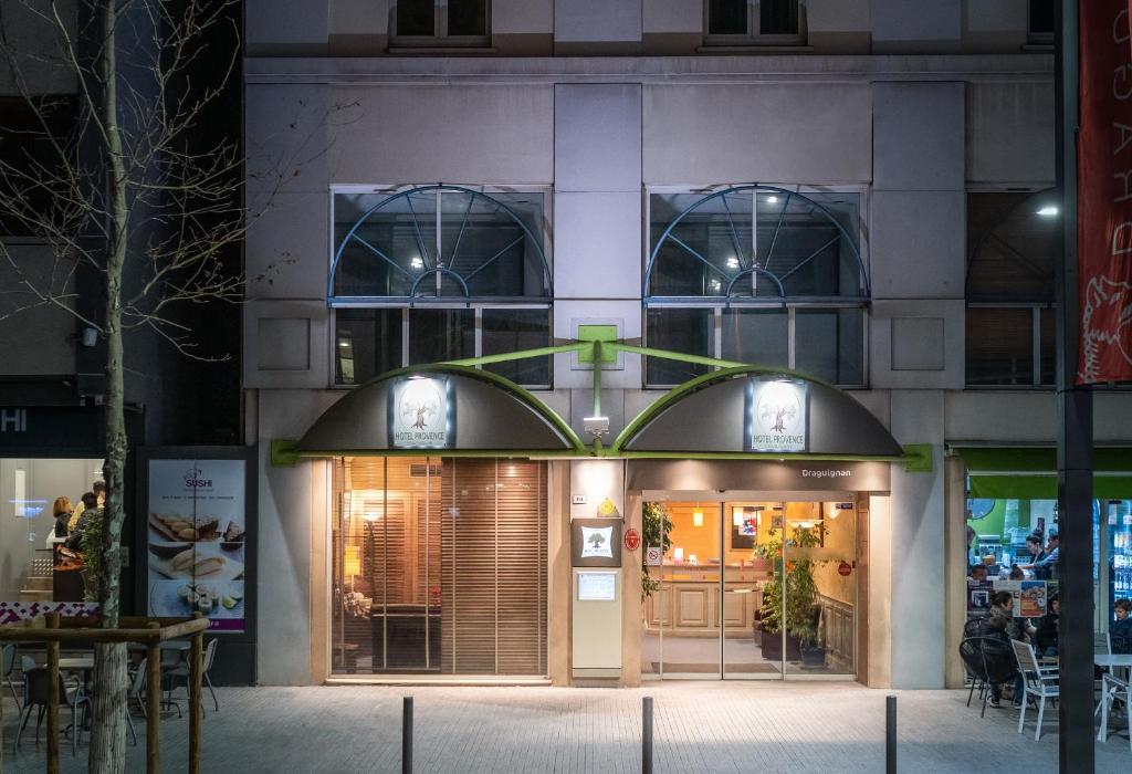 a store front of a building at night at Hôtel Provence in Draguignan